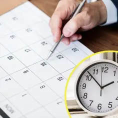 Ręka z długopisem zaznacza datę w kalendarzu, obok zegar pokazuje 1:50. Czas na planowanie najdłuższego dnia w roku.