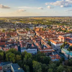 Widok z lotu ptaka na zabytkowe centrum Kalisza, najstarszego miasta w Polsce, z charakterystyczną architekturą i zielenią.